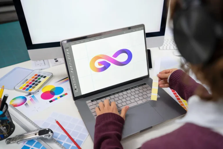 Graphic designer working on a laptop creating a professional logo design